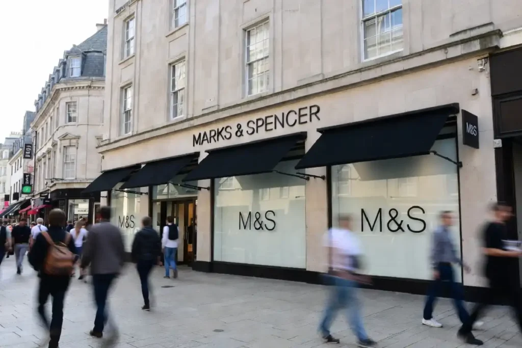 Exterior of a UK Marks and Spencer storefront on a busy shopping street