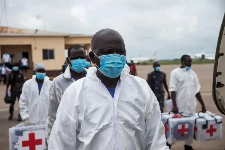 WHO official in protective gear arriving at Bunia airport during the DR Congo Ebola outbreak