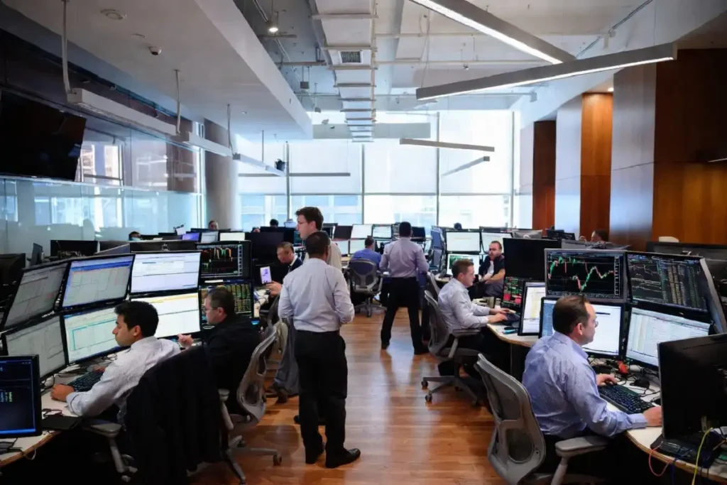 Wall Street traders monitoring spot Bitcoin ETF inflows on multiple screens