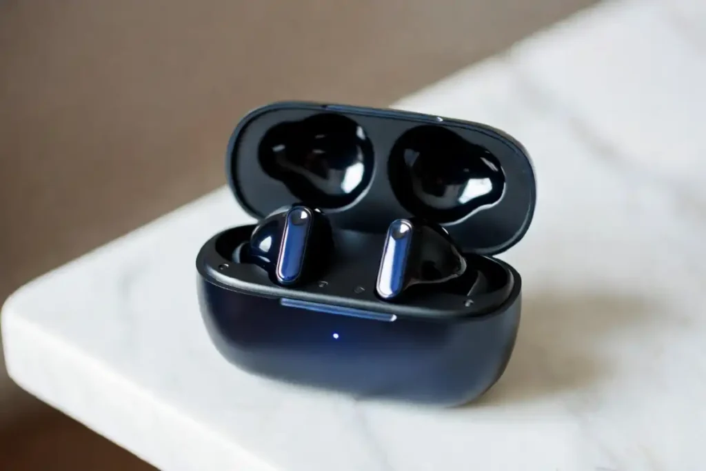 Modern wireless earbuds in open charging case with active noise cancellation feature