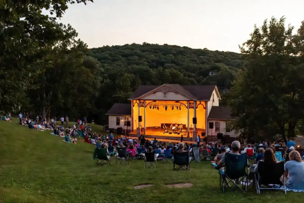 Adirondacks summer outdoor concert series at a historic park bandshell on a warm evening in upstate New York