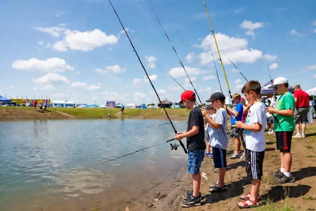 Kids catching and releasing bluegills at the Michigan DNR Pocket Park during the Upper Peninsula State Fair