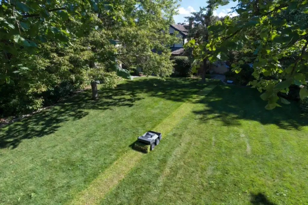 Yarbo M Series modular yard robot mowing a suburban lawn with boundary-wire-free navigation in summer 2026