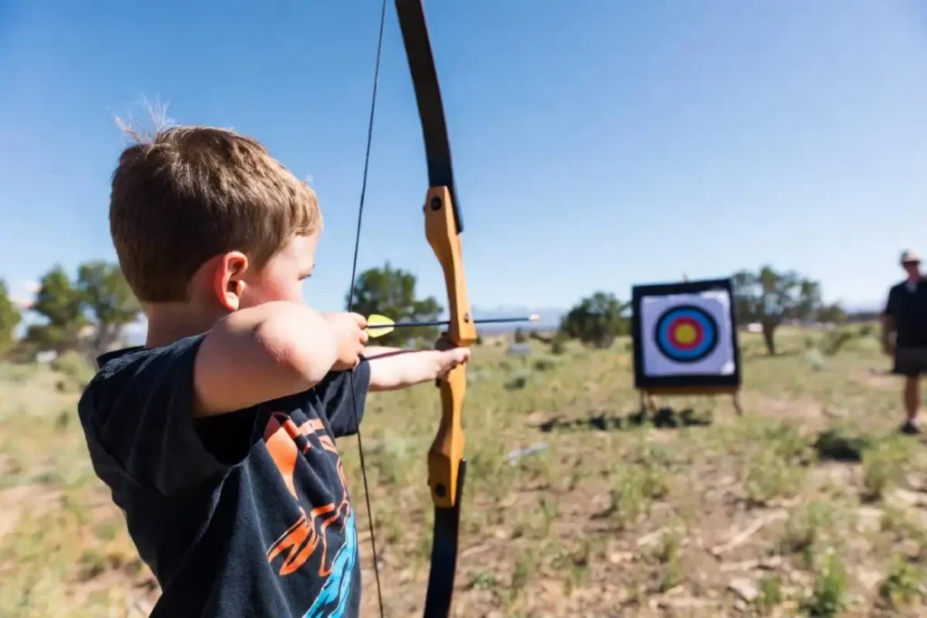 Child participating in archery range at Corrales Outdoor Adventure Day 2026