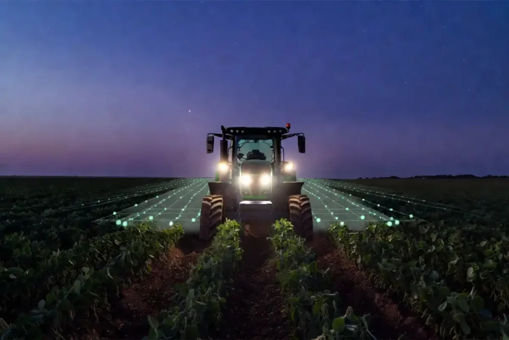 Autonomous farming pioneer equipment guiding a self-driving tractor through a soybean field