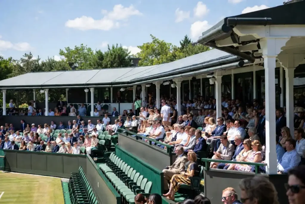 Royal Box guests in smart attire showing celebrity Wimbledon style at Centre Court